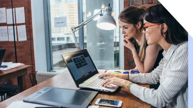 two females looking at a laptop screen