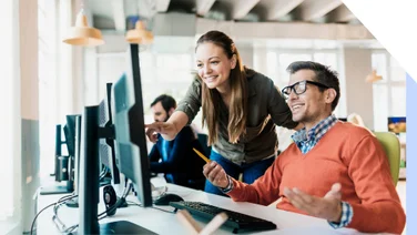 Man and woman work at same desktop screen