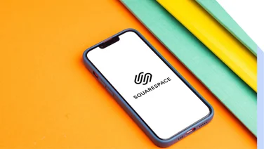 Screenshot of a phone with Squarespace logo on the screen, on top of an orange background