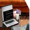 Laptop on a table displaying a blog dashboard with a cup of coffee and books in the background