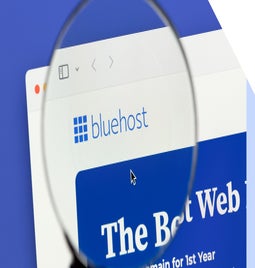 Magnifying glass hovering over the Bluehost logo on the desktop homepage