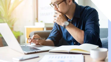 A man looking at his laptop while looking.