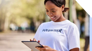 Volunteer smiles at tablet