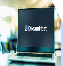 Laptop screen showing the DreamHost logo against a black background