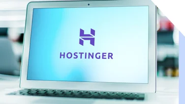 Silver laptop showing the Hostinger logo on the screen