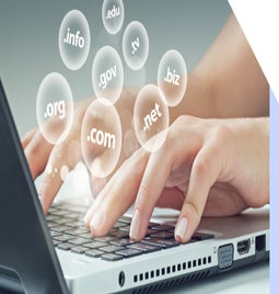 Woman's hands typing at a laptop with clear bubbles floating above showing different domain name extensions