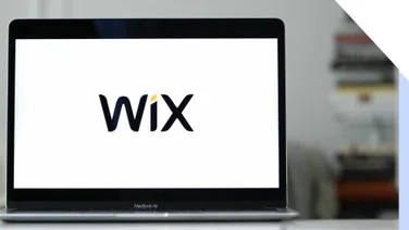 Laptop with a white screen showing the Wix logo