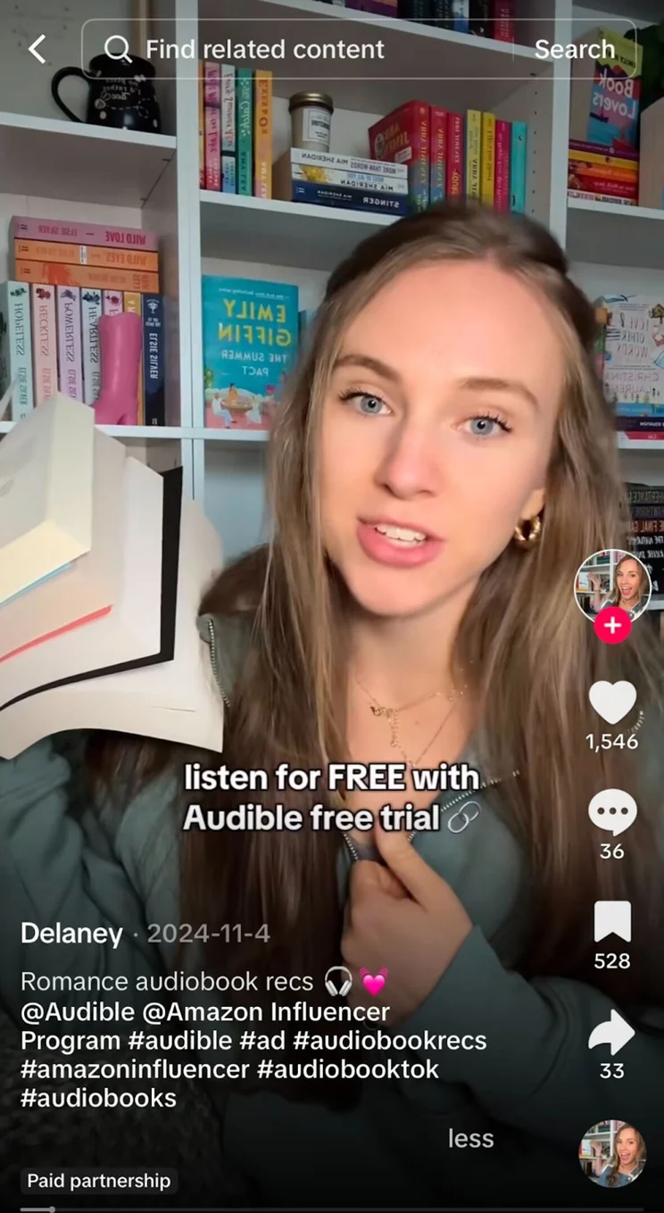 woman holding up books and talking in a TikTok ad for audible