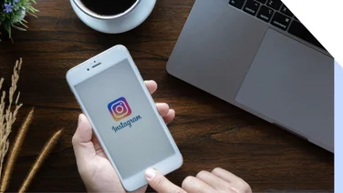 instagram logo on a white iphone help over a brown table