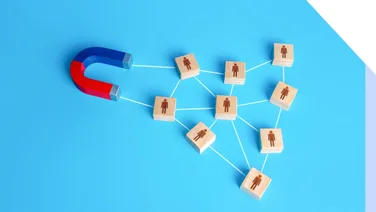 Photo of a magnet connected to counters featuring outlines of people