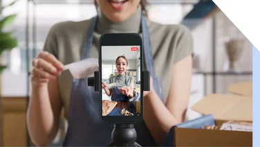 female chef filming herself making food on an online livestream