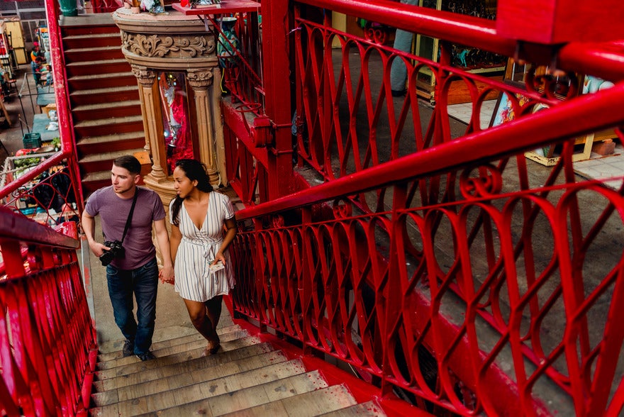 Jim and May walking up red staircase