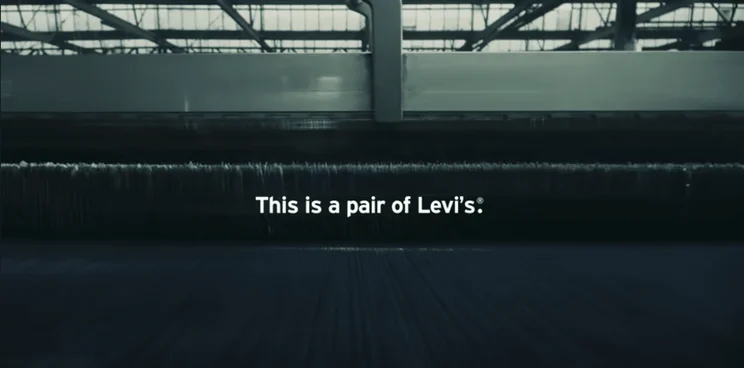 Still from Levi's video showing the manufacturing of jeans captioned "This is a pair of Levi's"