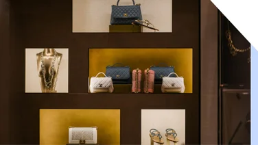 A store display featuring luxury handbags and jewelery