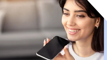 A woman holding a phone to her mouth for a voice search