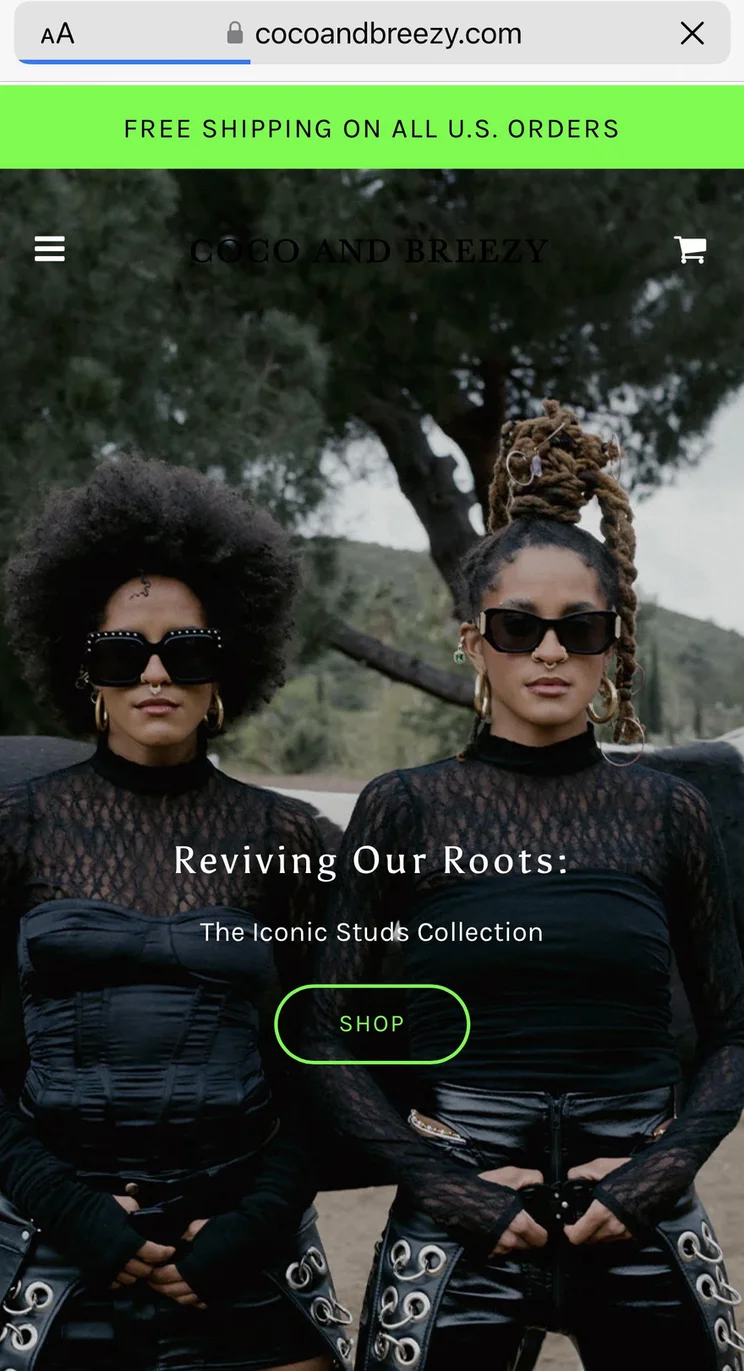 A photo of two young women in black sunglasses and slick outfits. There's a "Revive Our Roots" title.