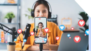 girl vlogging for social media on phone with graphic hearts
