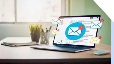Laptop open with inbox receiving emails
