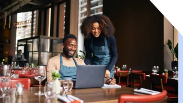 Restaurant managers working with laptop