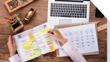 Desk covered with planning and scheduling materials