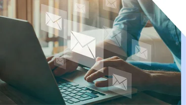 Close up of person typing on laptop with images or emails on top.
