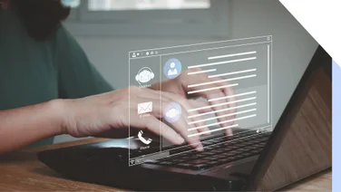 Person typing on laptop with a hologram of a messaging platform above the keyboard
