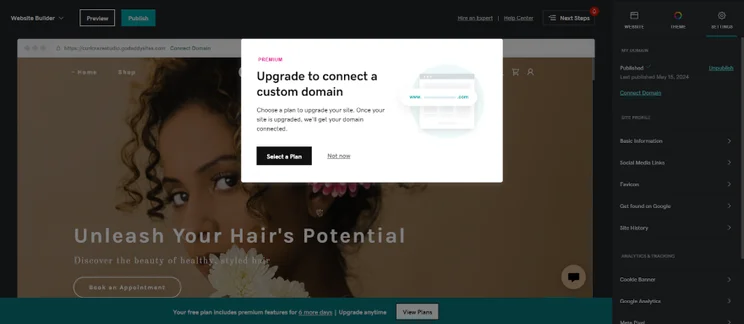 Screenshot of GoDaddy Pop-up notification to update plans to upload a custom domain to website.