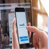 Person holding a mobile device with the LinkedIn login page on the screen