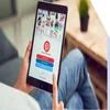 Person sat holding a tablet with the Pinterest login page on the screen