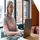 A focused professional woman working diligently on a laptop in an office setting