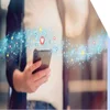Person holding mobile phone with stream of social media icons flowing above it