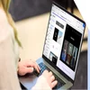 A professional woman working intently on building a website on her laptop.