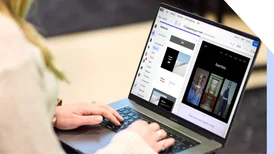 A professional woman working intently on building a website on her laptop.