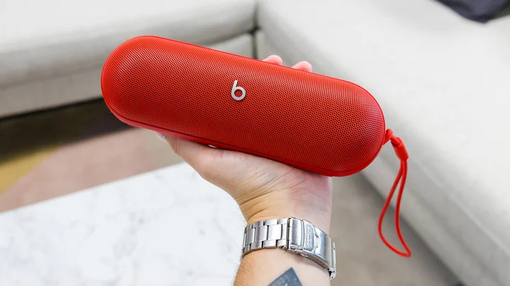 red beats pill speaker being held in a hand