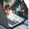 hands typing on laptop keyboard with SEO text hologram