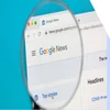 A magnifying glass zooming into the Google news webpage