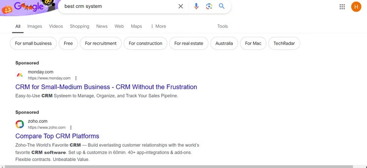 Screenshot of a Google results page for "best CRM system" and sponsored results at the top