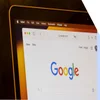 Apple laptop screen showing a browser with the Google homepage