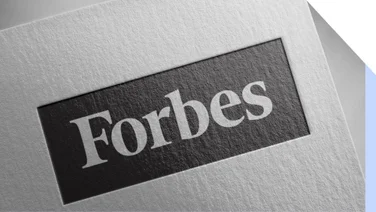 White piece of paper with the Forbes logo printed on it