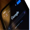 Mobile showing the Google search homepage in dark mode