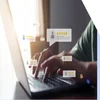 Person typing at a laptop with floating customer reviews around the hand
