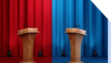 Photo of curtains with a red and blue side and podiums at each end
