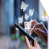 Shopping cart icons floating out of a mobile phone