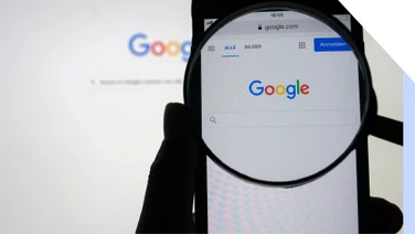 Photo of a desktop and phone with the google chrome browser on screen and a magnifying glass