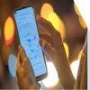 Person holding a mobile device showing Google Maps on the screen