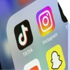 Photo of a phone closeup showing the icons for TikTok and Instagram