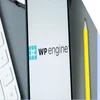 Closeup of a phone with the WP Engine logo on the screen