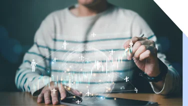 Person monitoring a rising chart with little human figures scattered throughout