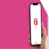 Photo of a hand holding a smartphone with the Instagram Reels logo on screen