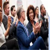 Businessmen and women sat down at a conference and clapping